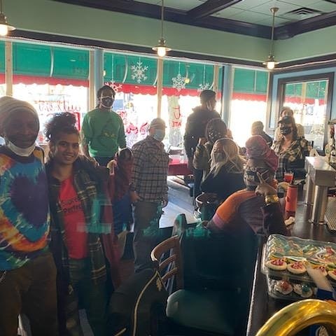 Trasition Program staff serving Thanksgiving dinner to the homeless in collaboration with Black Umbrella andTutto Pasta